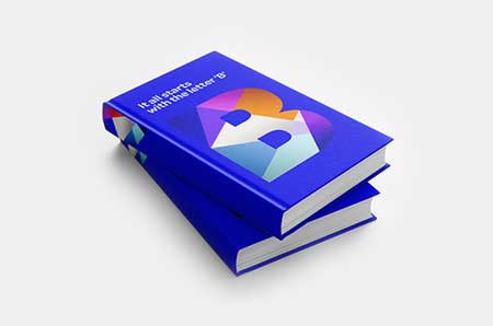 Hardcover books in blue with letter B on the front cover on light grey background